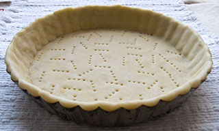 Unbaked Pâte Sucrée in a tart pan