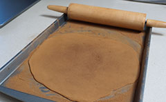 Dusting dough with cinnamon